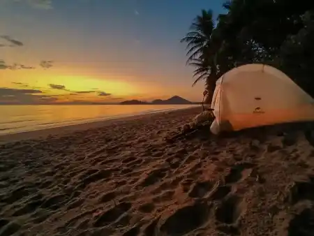 Tent between sea and natives